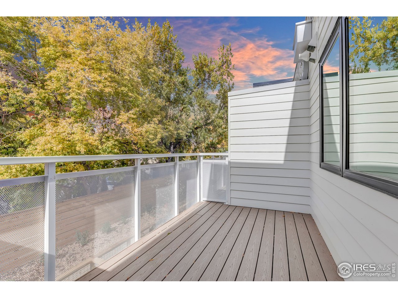 3261 Airport Road, Unit 204 Boulder, CO 80301 - Photo 15 of 36 a view of a balcony with wooden floor and fence