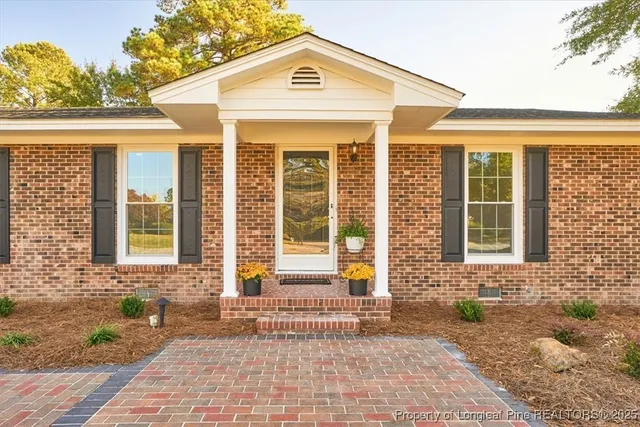a view of a brick house with a large windows