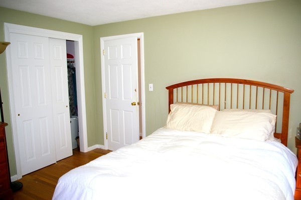 59 Joyce Road Framingham, MA 01701 - Photo 19 of 30 a bedroom with a bed and a painting on the wall