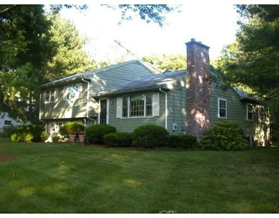 59 Joyce Road Framingham, MA 01701 - Photo 2 of 30 a front view of a house with a garden and plants