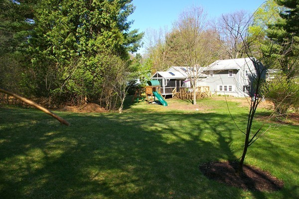 59 Joyce Road Framingham, MA 01701 - Photo 26 of 30 a view of yard with swimming pool and trees in the background
