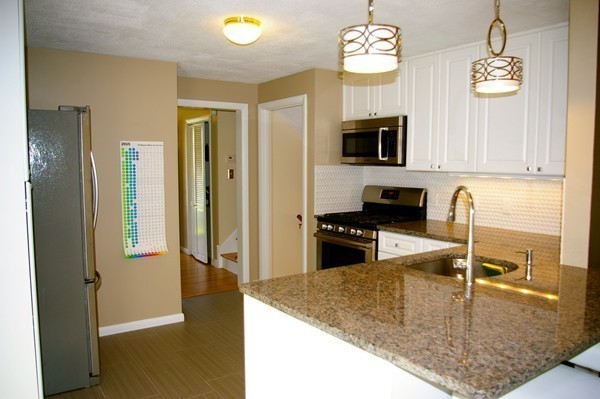 59 Joyce Road Framingham, MA 01701 - Photo 3 of 30 a kitchen with stainless steel appliances granite countertop a refrigerator a stove and a sink with granite countertops