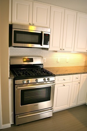 59 Joyce Road Framingham, MA 01701 - Photo 5 of 30 a stove top oven sitting inside of a kitchen