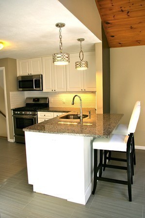 59 Joyce Road Framingham, MA 01701 - Photo 7 of 30 a kitchen with kitchen island a sink table and chairs