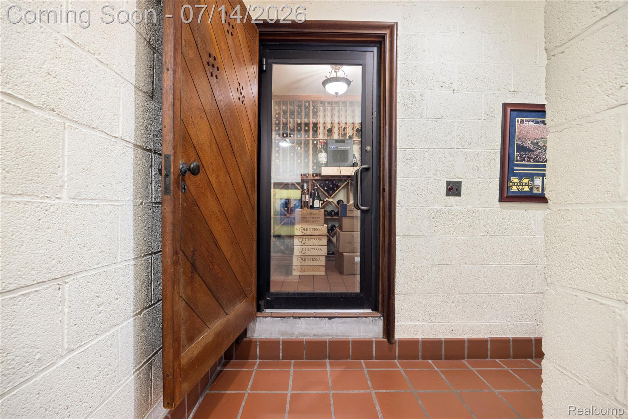 189 Cloverly Road Grosse Pointe, MI 48236 - Photo 65 of 96 Custom wood door with diamond-patterned accents opening to an interior space featuring a glass-paneled door