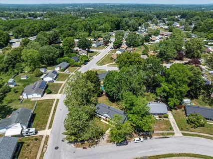 an aerial view of a house with a yard