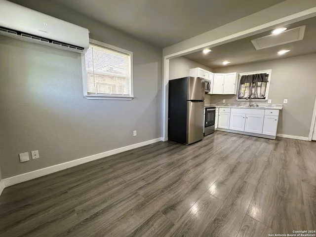 a view of kitchen with stainless steel appliances refrigerator microwave and stove