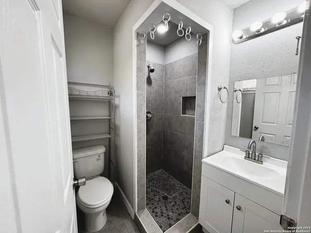 a bathroom with a sink toilet and shower