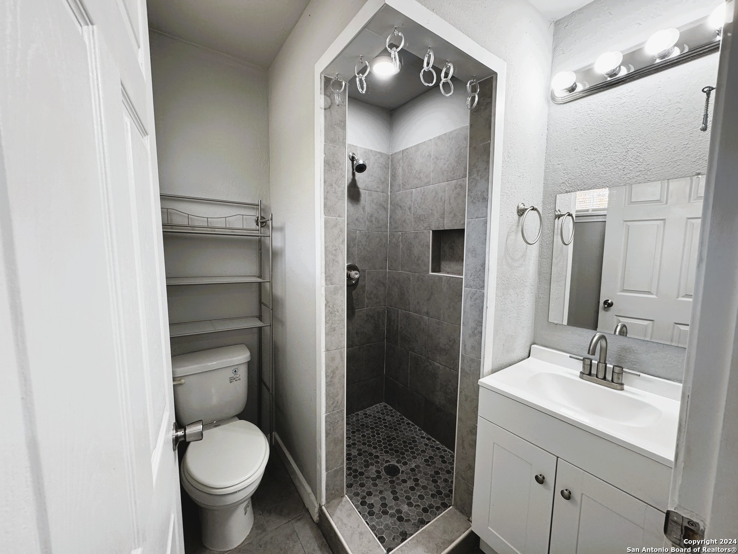 1914 Cupples Road San Antonio, TX 78226 - Photo 6 of 6 a bathroom with a sink toilet and shower