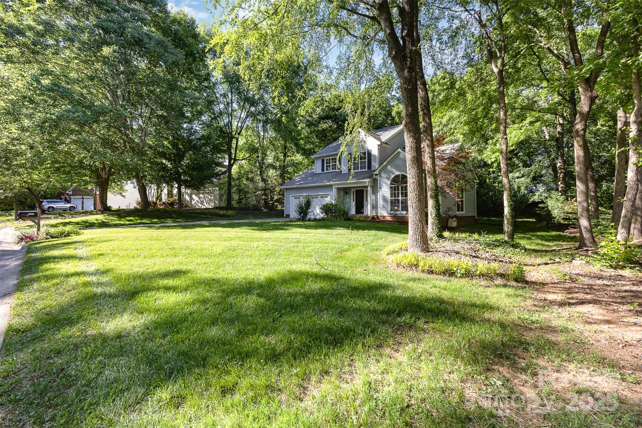 7226 Reedy Creek Road Charlotte, NC 28215 - Photo 3 of 37 a view of a house with a big yard and large trees