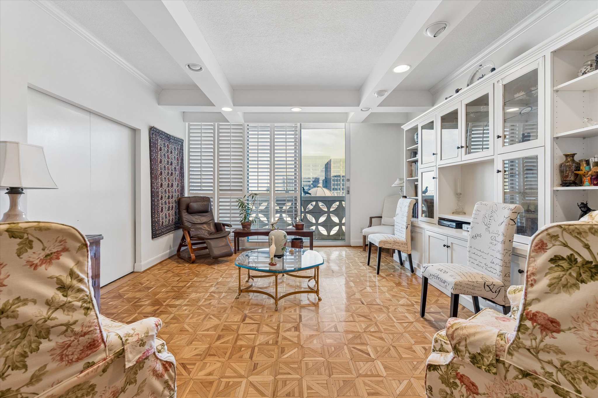 1801 Lavaca Street, Unit 6E Austin, TX 78701 - Photo 1 of 32 Living area featuring real parquet flooring, coffered ceiling, a textured ceiling, and recessed lighting