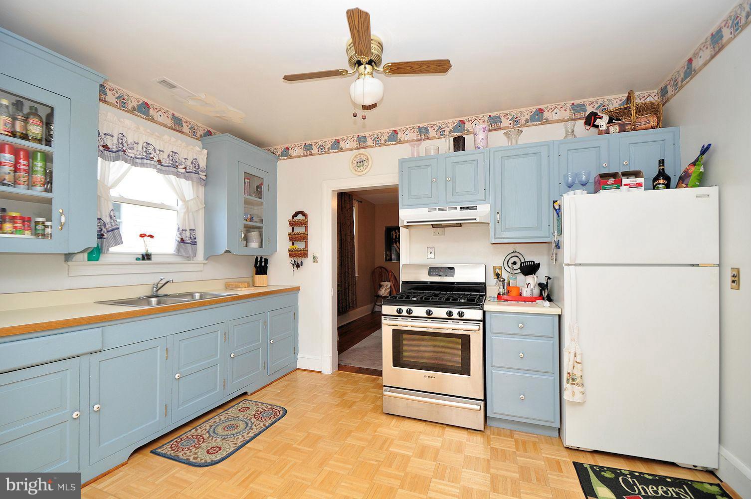 642 Coleraine Road Baltimore, MD 21229 - Photo 14 of 26 a kitchen with refrigerator cabinets and window