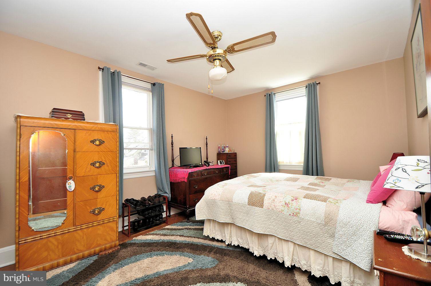642 Coleraine Road Baltimore, MD 21229 - Photo 16 of 26 a bedroom with a bed and wooden floor