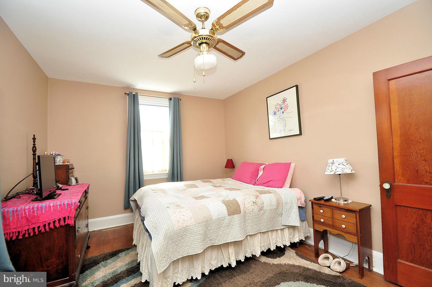 642 Coleraine Road Baltimore, MD 21229 - Photo 17 of 26 a bedroom with a bed and a chandelier