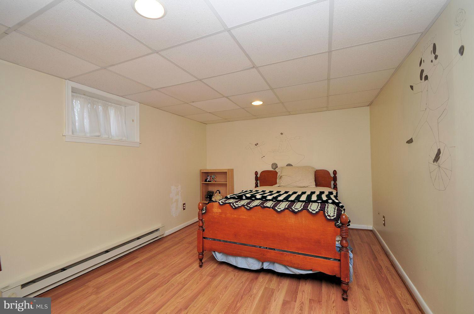 642 Coleraine Road Baltimore, MD 21229 - Photo 20 of 26 a bedroom with a bed and a dresser