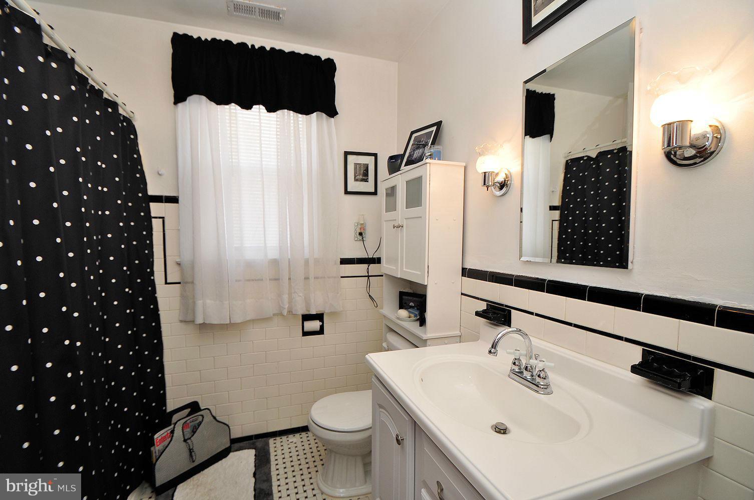 642 Coleraine Road Baltimore, MD 21229 - Photo 21 of 26 a bathroom with a sink toilet and shower