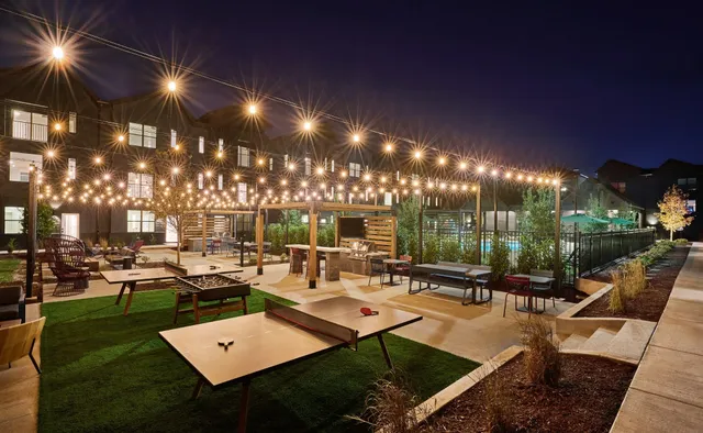 a view of a yard tables and chairs in a patio