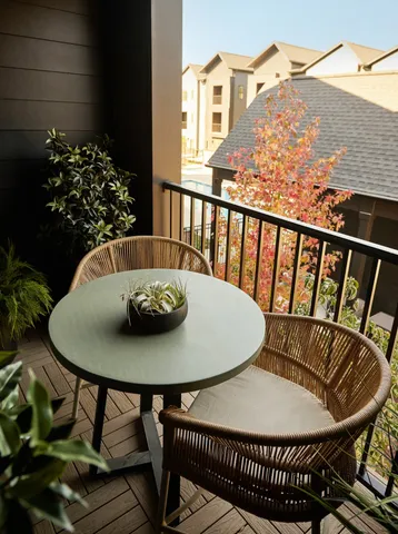 a view of a chairs and table in the balcony