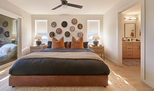 a bedroom with a bed and a painting on the wall