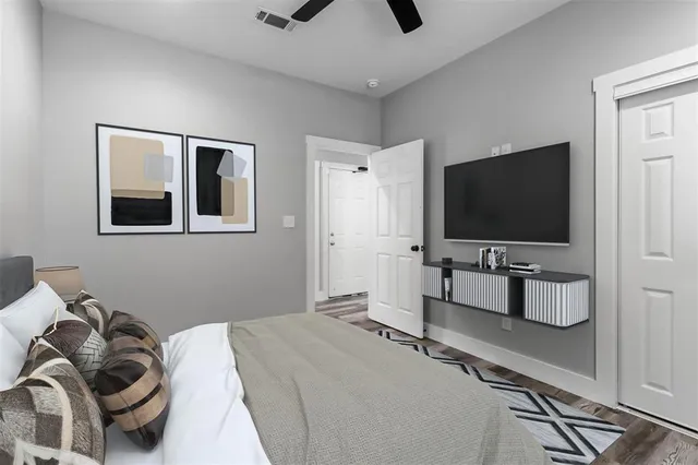 a bedroom with a bed and a flat screen tv