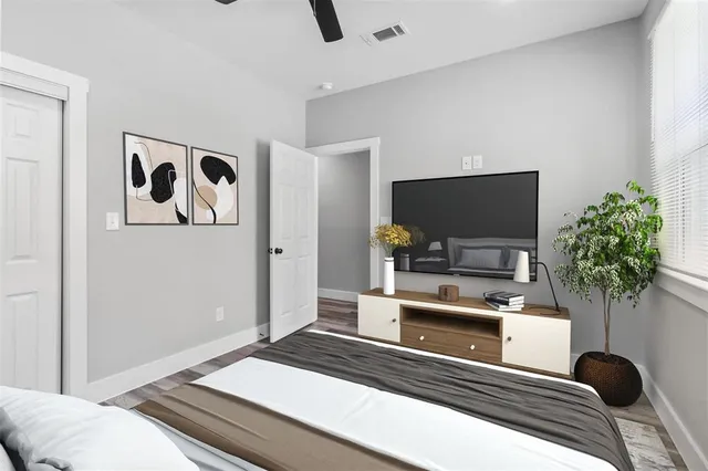 a bedroom with a bed and a flat screen tv