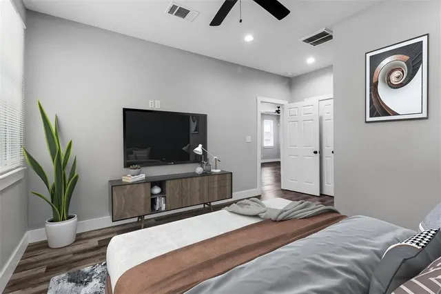 a bedroom with a bed and a flat screen tv