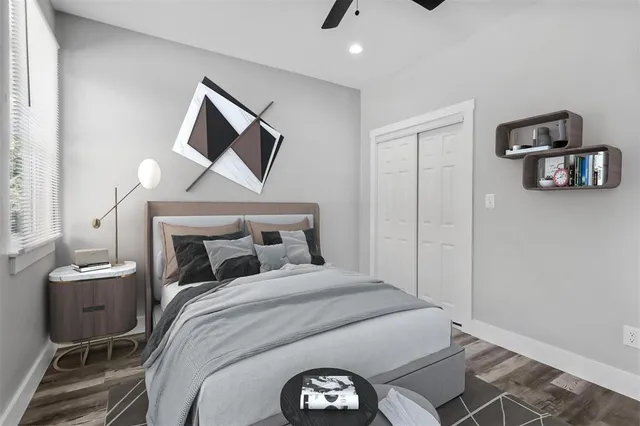 a bedroom with a bed and painting on the wall