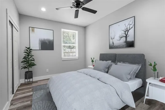 a bedroom with a large bed and a potted plant