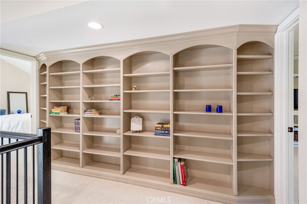 109 Cinnamon Ridge Road Brea, CA 92821 - Photo 32 of 67 At top of staircase is large custom shelving with plenty of room for books, nick knacks, etc...