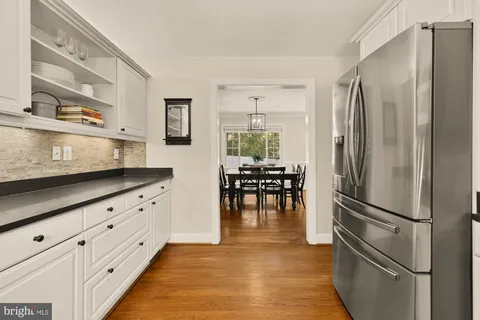 a kitchen with stainless steel appliances a stove microwave and a refrigerator