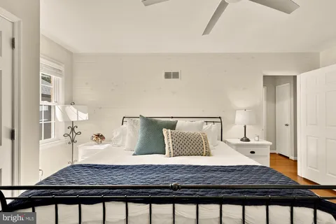 a bedroom with a bed and a couch