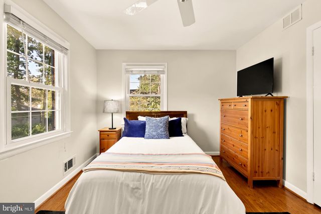 a bedroom with a bed and flat screen tv