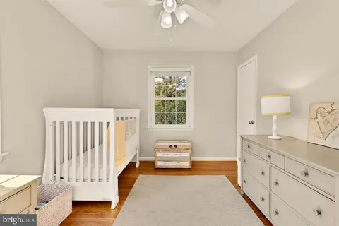 a spacious bedroom with a bed and a chandelier