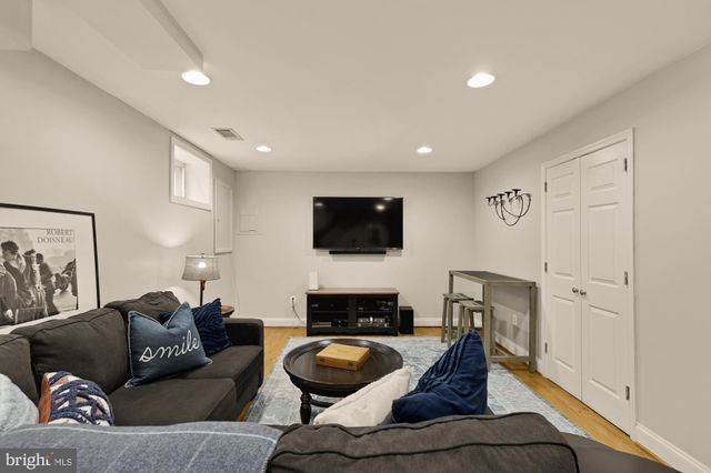 a living room with furniture a rug and a table