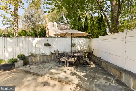 a view of a house with backyard porch and sitting area