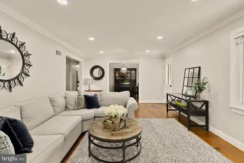 a kitchen with a table chairs and wooden floor