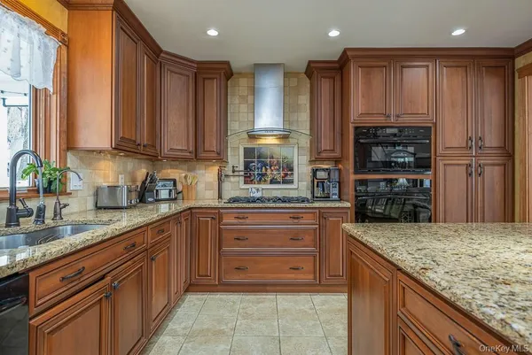a kitchen with stainless steel appliances granite countertop wooden cabinets and a granite counter tops