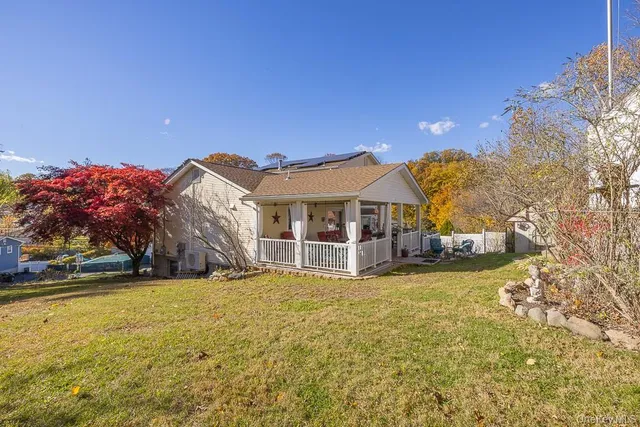 a view of a backyard with wooden fence