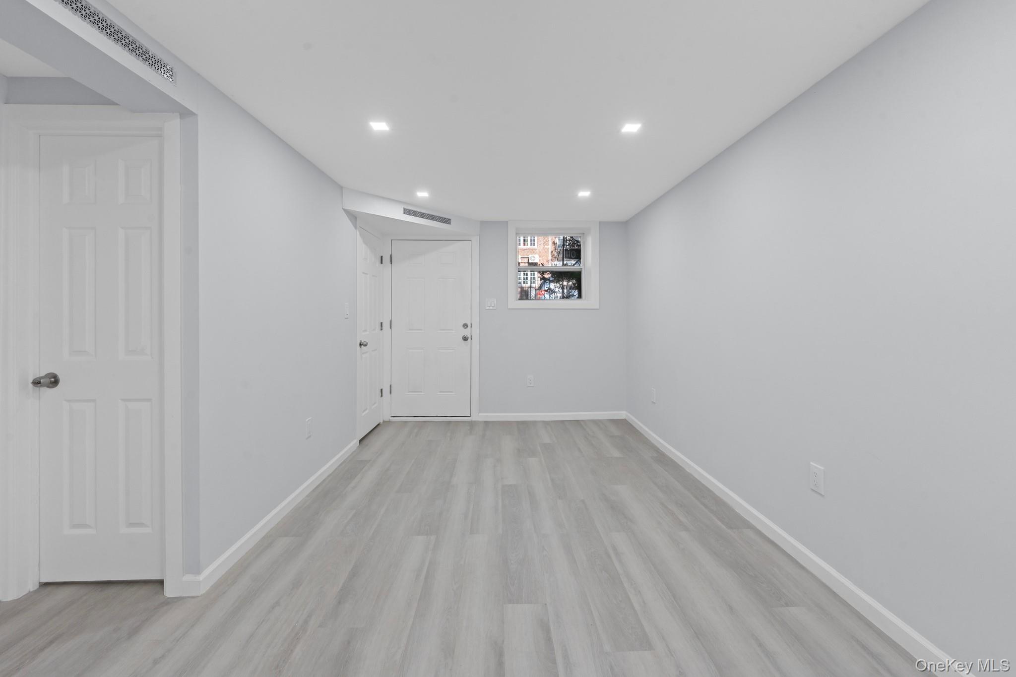 110-08 172nd Street Queens, NY 11433 - Photo 12 of 15 a view of empty room with wooden floor