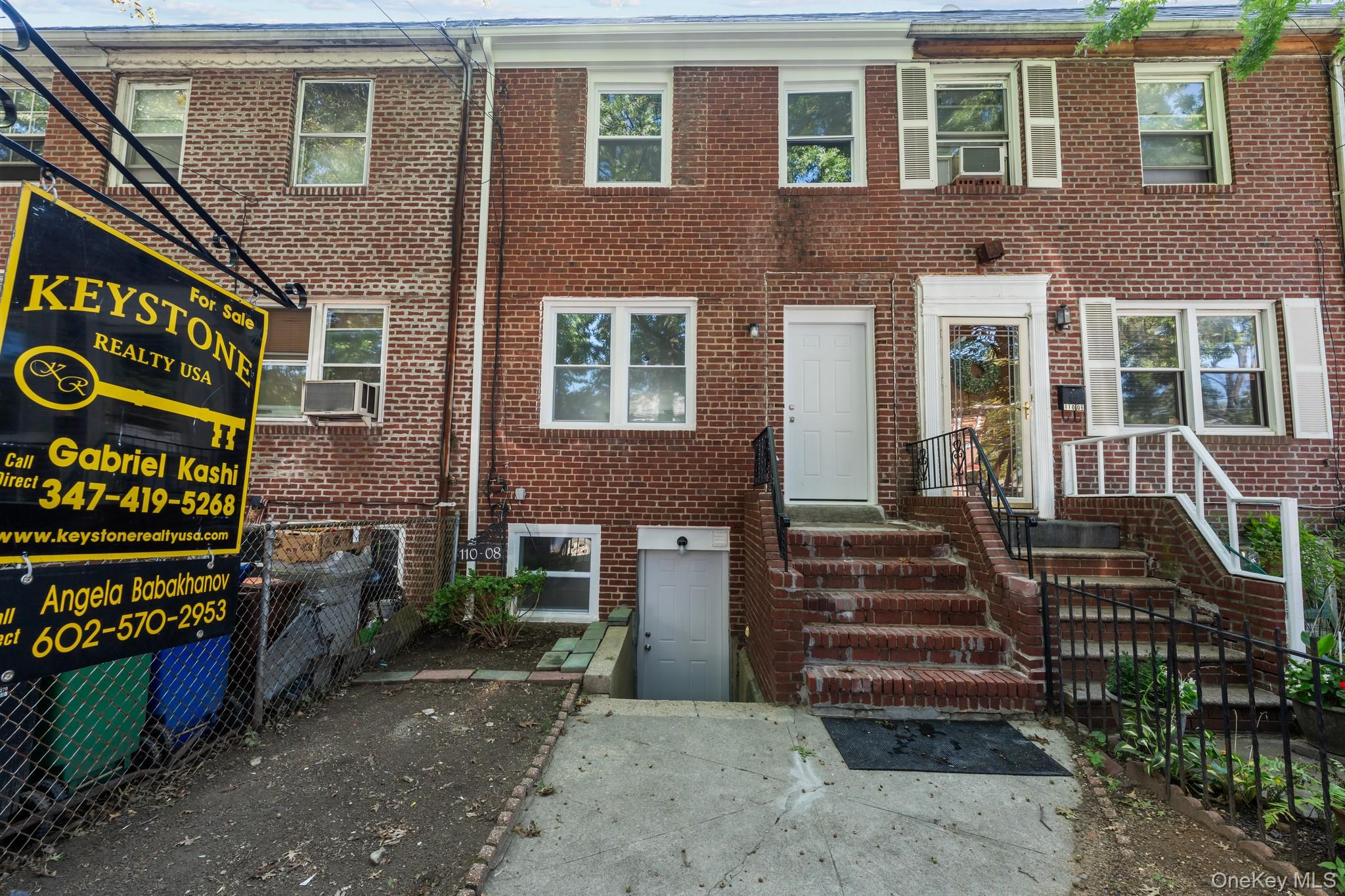 110-08 172nd Street Queens, NY 11433 - Photo 15 of 15 front view of a house with a small yard