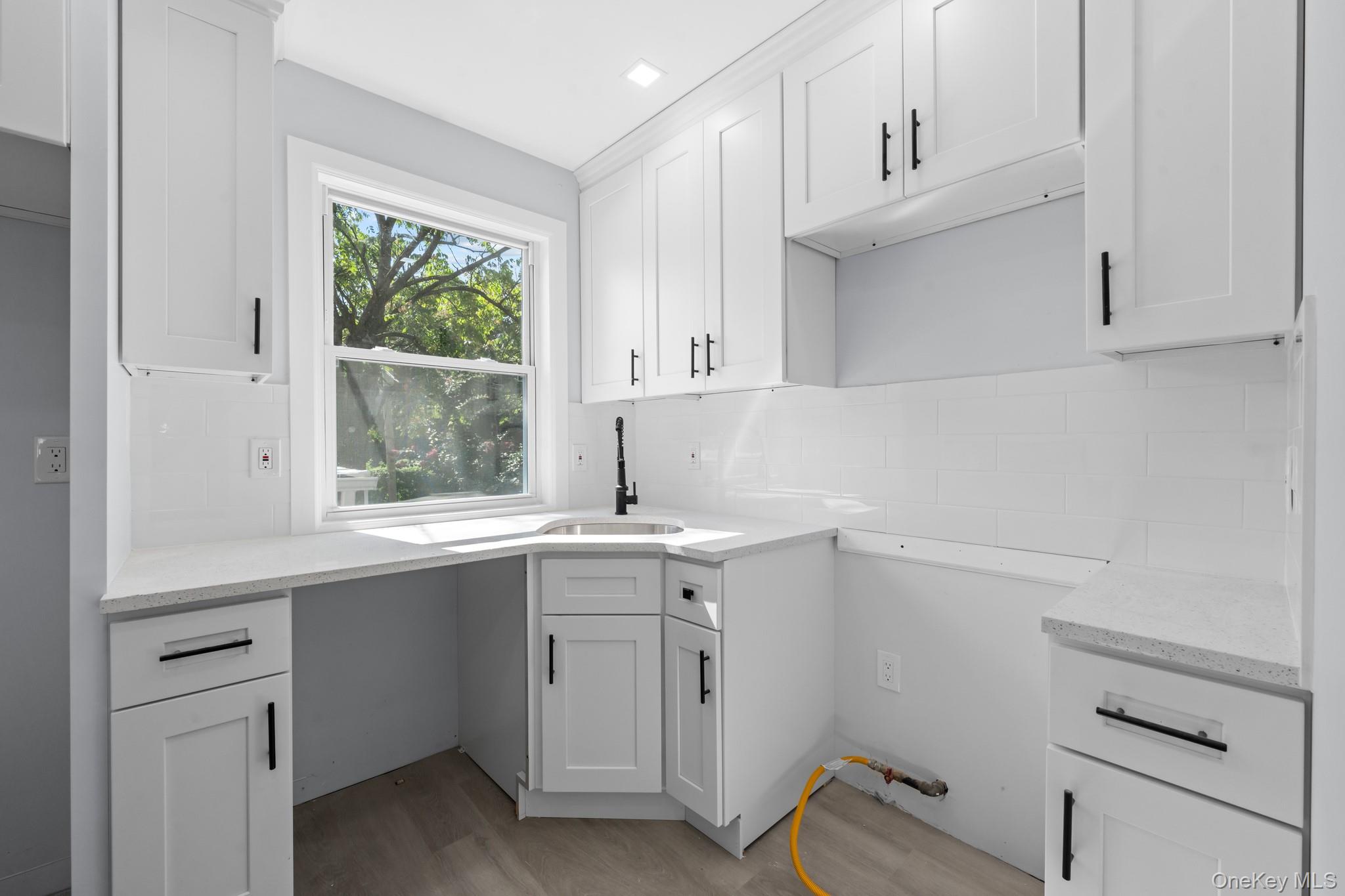 110-08 172nd Street Queens, NY 11433 - Photo 2 of 15 a kitchen with a sink cabinets and window