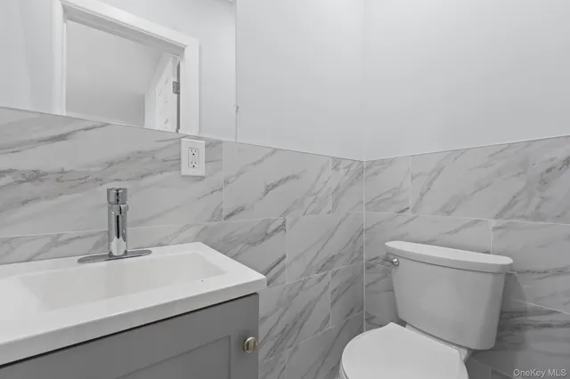 a white toilet sitting next to a bathroom sink