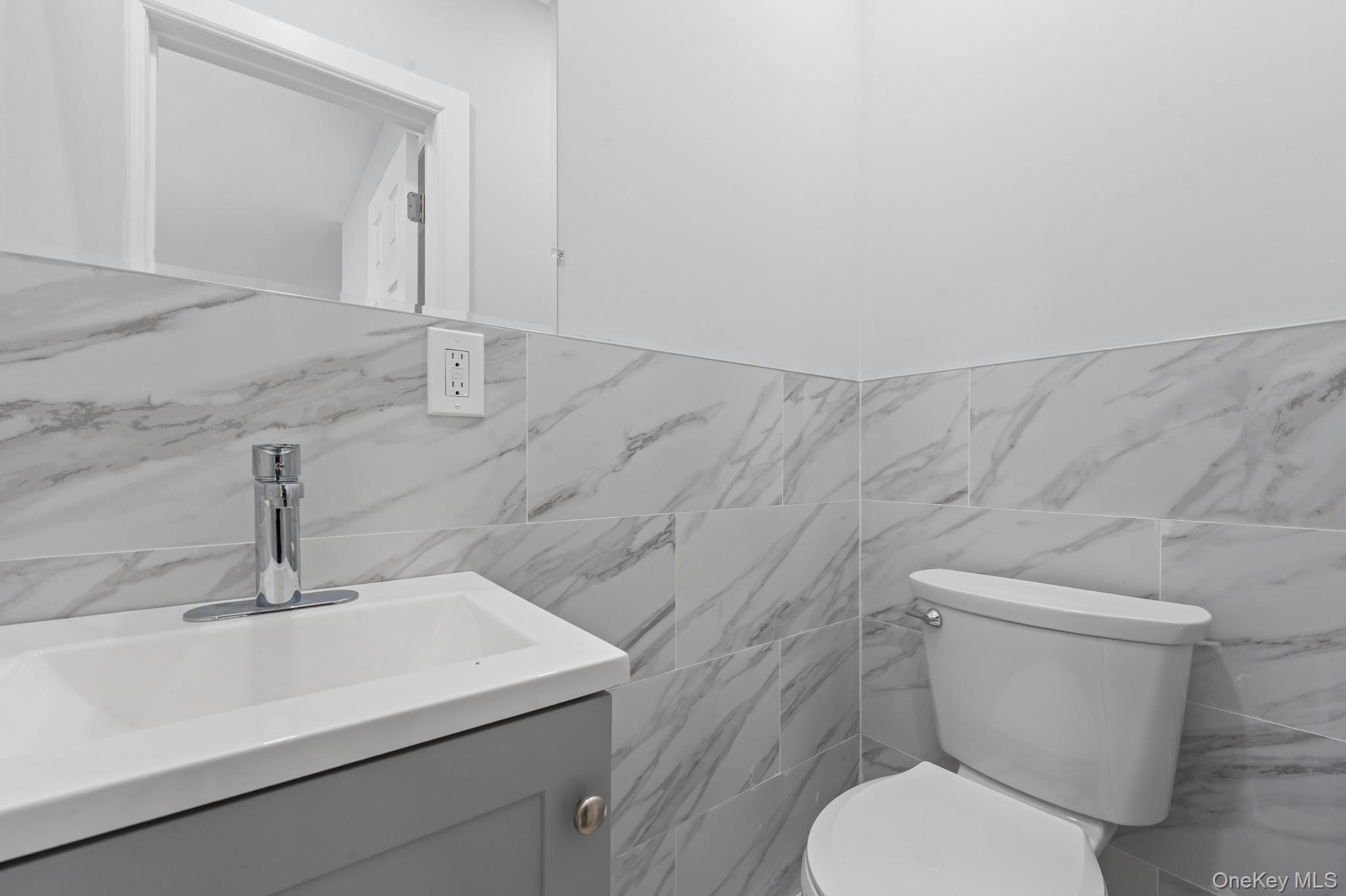 110-08 172nd Street Queens, NY 11433 - Photo 5 of 15 a white toilet sitting next to a bathroom sink