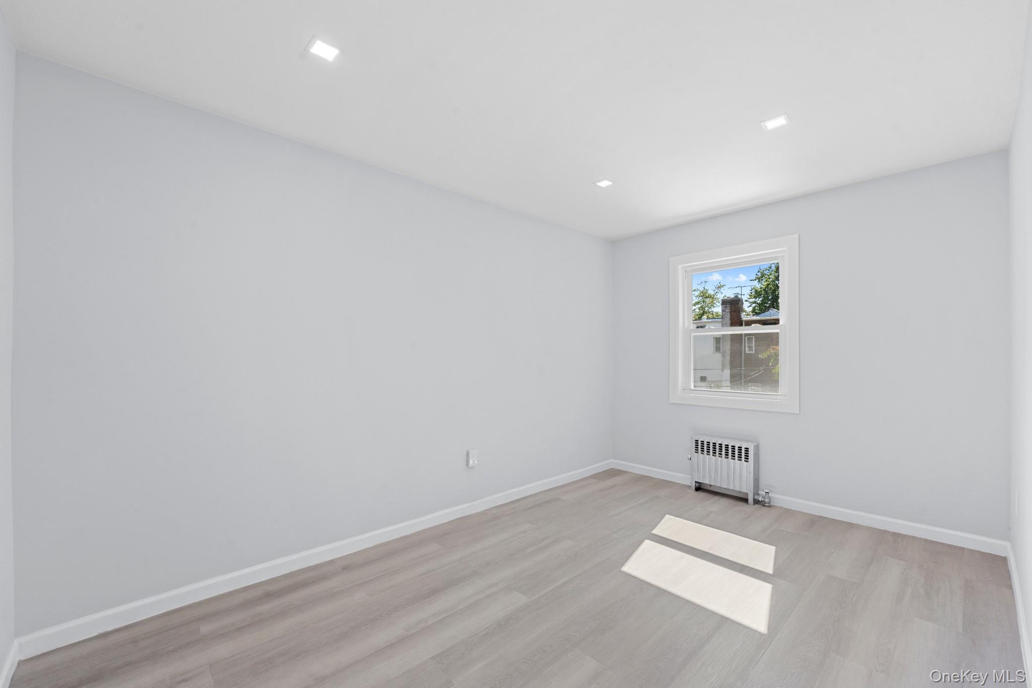 110-08 172nd Street Queens, NY 11433 - Photo 6 of 15 an empty room with a workbench