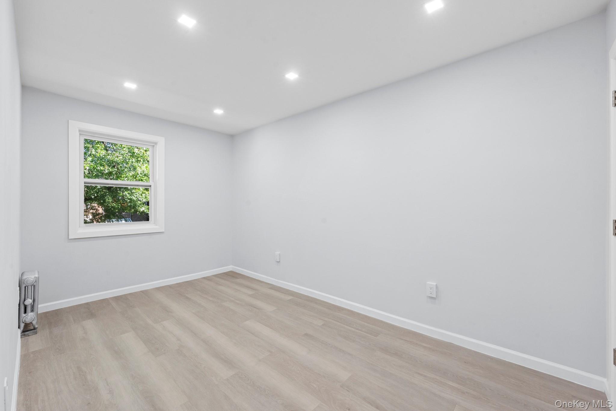 110-08 172nd Street Queens, NY 11433 - Photo 7 of 15 an empty room with a window