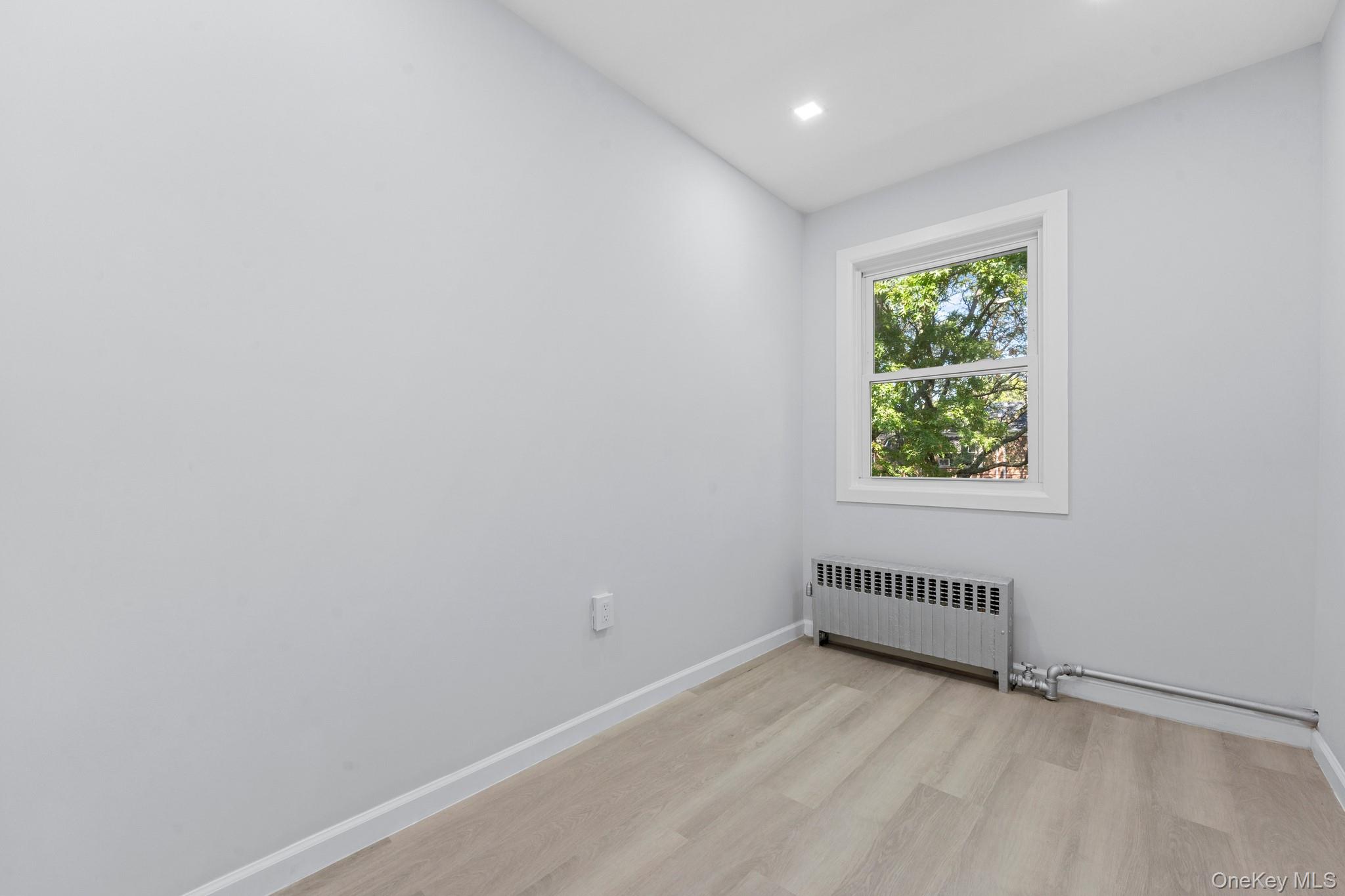110-08 172nd Street Queens, NY 11433 - Photo 8 of 15 an empty room with a window