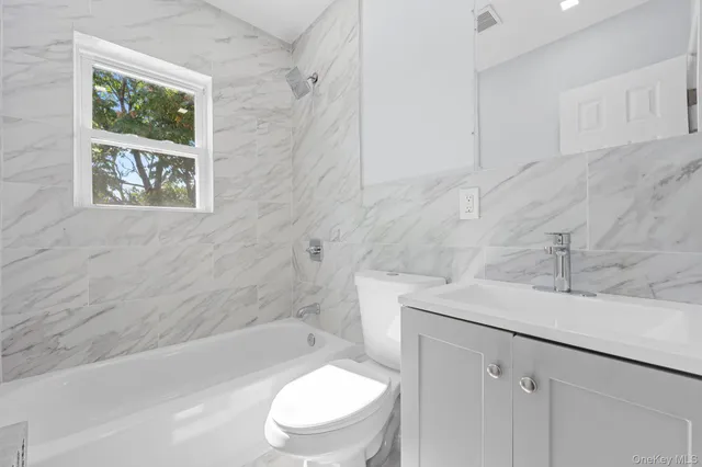 a bathroom with a sink a toilet and bathtub