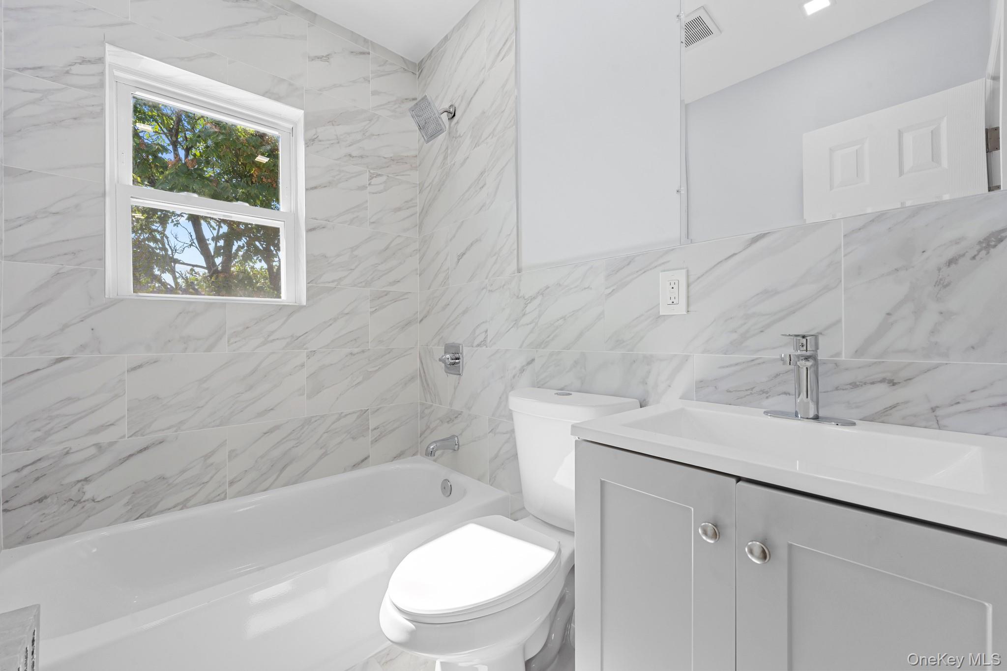 110-08 172nd Street Queens, NY 11433 - Photo 9 of 15 a bathroom with a sink a toilet and bathtub