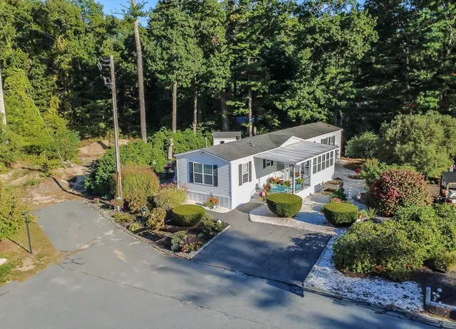 an aerial view of a house with swimming pool garden view and trees
