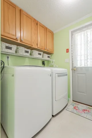 a front view of house with yard and trees in the background